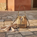 Woven handbag with a drawstring closure on a white background